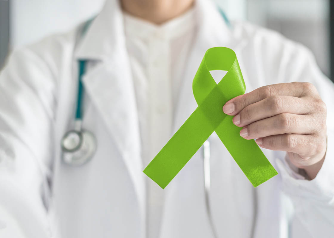 Lime Green Ribbon In Doctorâ??s Hand For Lymphoma Cancer And Mental Health Awareness, Raising Support And Help Patient Living With Illness