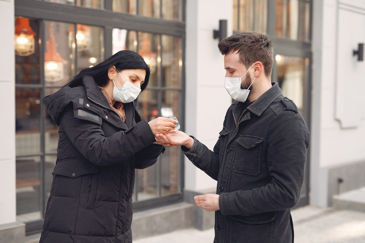 Woman Putting Hand Sanitizer On Man S Hand 3983406