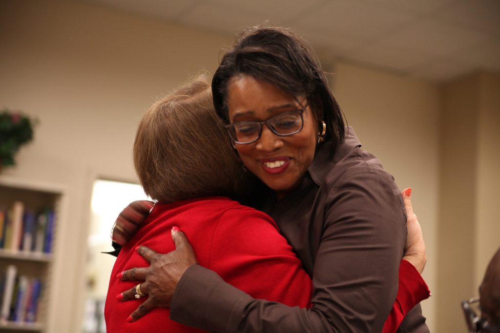 Provost Elizabeth A. Dooley hugging a staff member