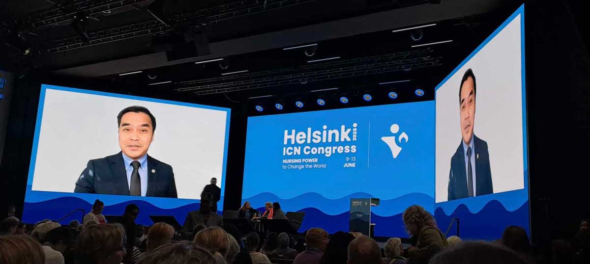 Dr. Michael Joseph Dino appears on two large video screens above the stage at the 2025 International Council of Nurses Congress in Helsinki.