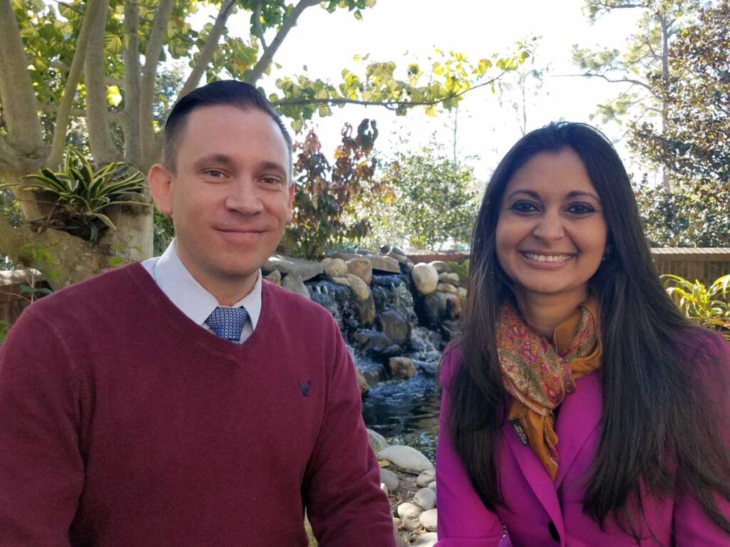 Shreya Trivedi, University Ombuds Officer, and Daniel Thompson, Deputy Ombuds, sitting outside.